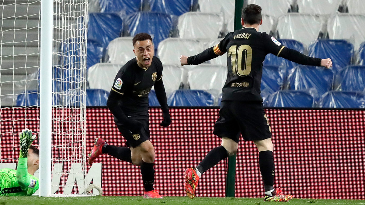 Sergiño Dest celebrates with Lionel Messi after scoring for Barcelona